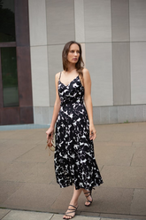 a lady in a black and white dress